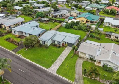 Aerial drone photography of residential neighbourhood streets, homes, and lawns for property listings.