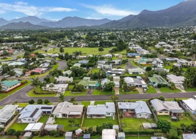 Scenic aerial drone landscape view of a suburban area with mountain backdrop for property marketing.