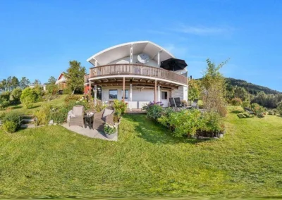 Stitched 360 exterior panorama of a residential property with clear blue skies and sharp landscaping.