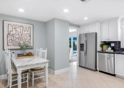 Clean modern kitchen and breakfast area with professional brightness adjustment and lens correction.