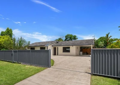A suburban house with a bright, clear blue sky added through professional photo editing services.