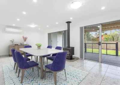 Elegant virtual staging in a dining area featuring vibrant purple chairs, ideal for high-end property marketing.
